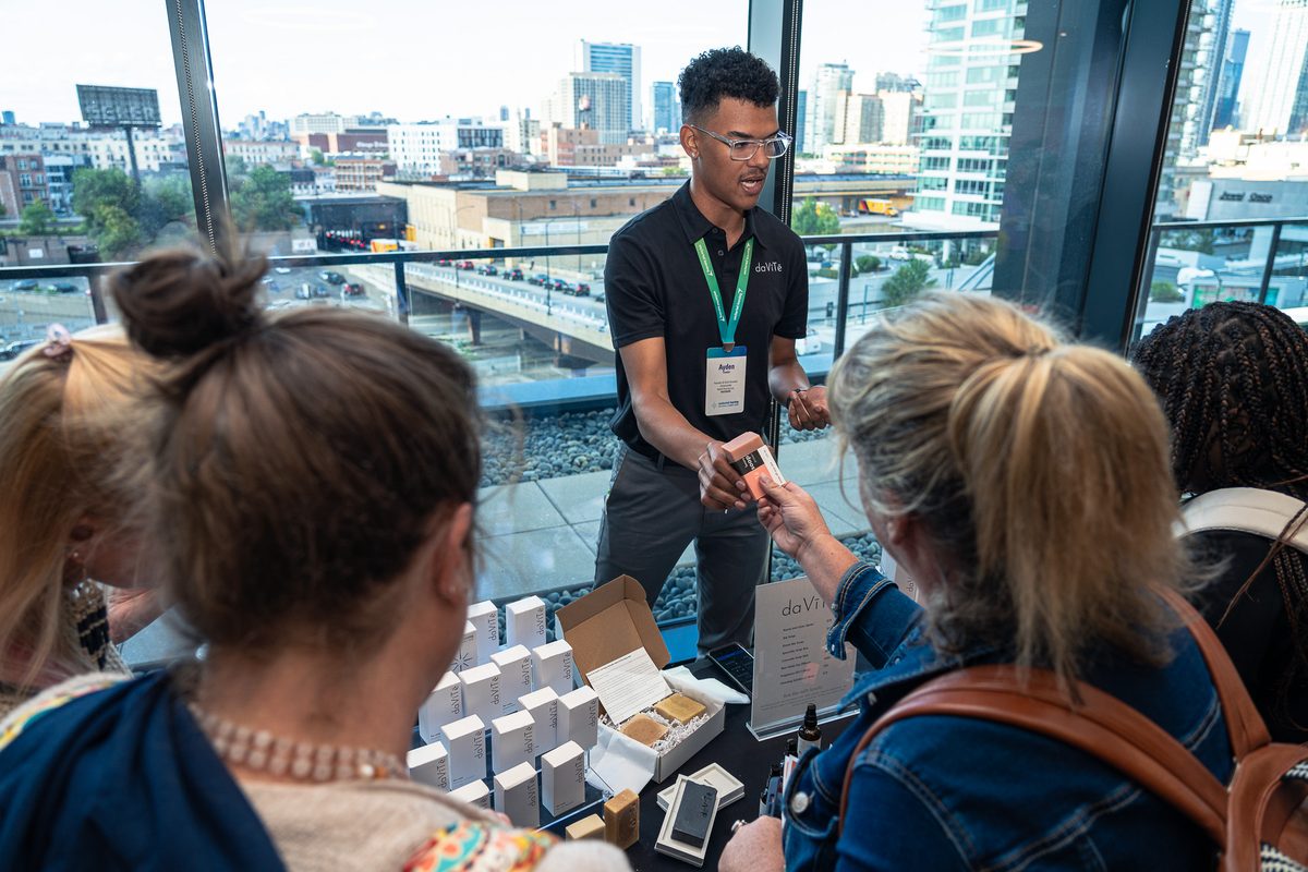 Ayden presenting scent products to an audience