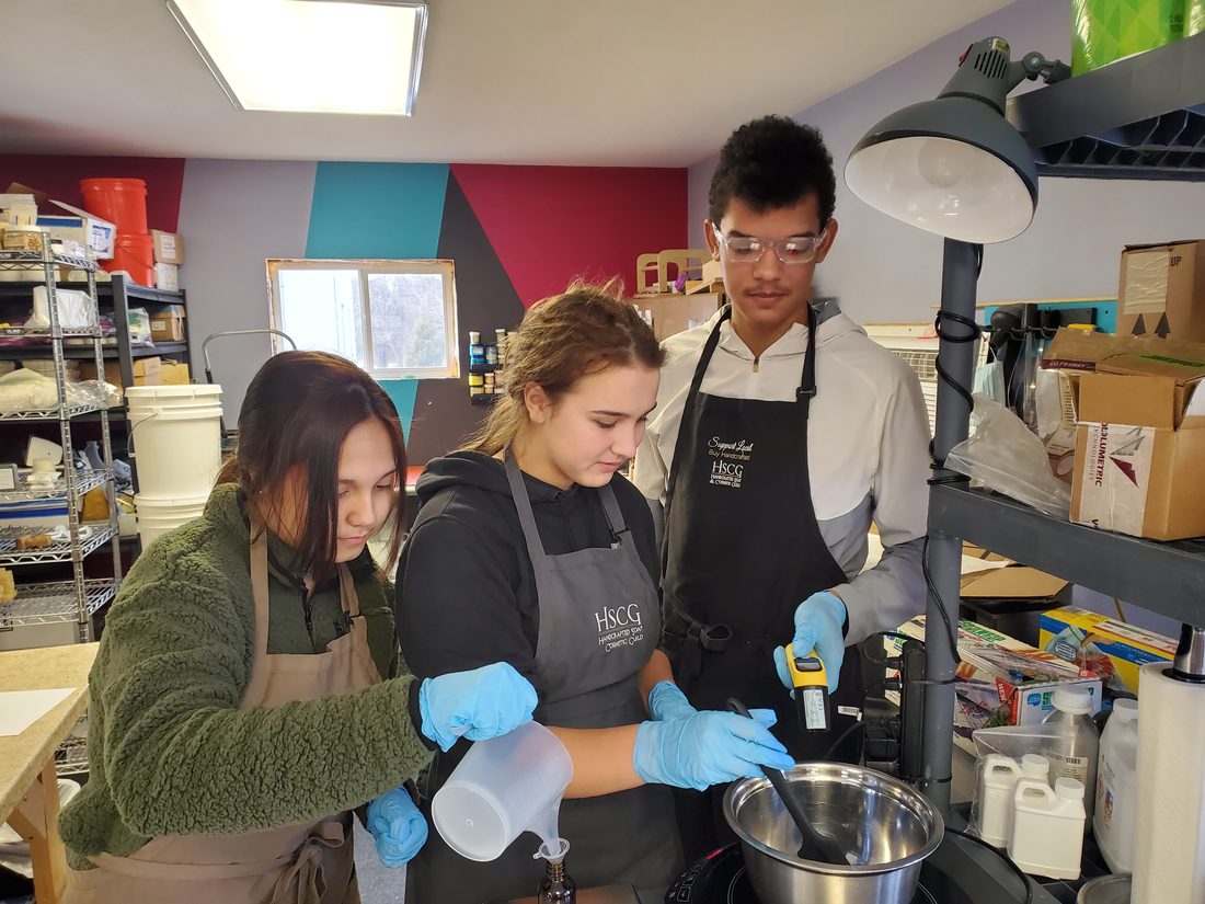 Ayden making soap in a workshop