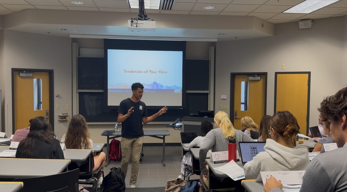 Ayden teaching a college class with a GRiT Tendencies of Your Voice slide