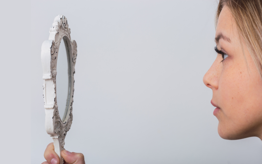 woman looking in mirror