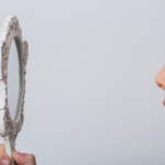 woman looking in mirror